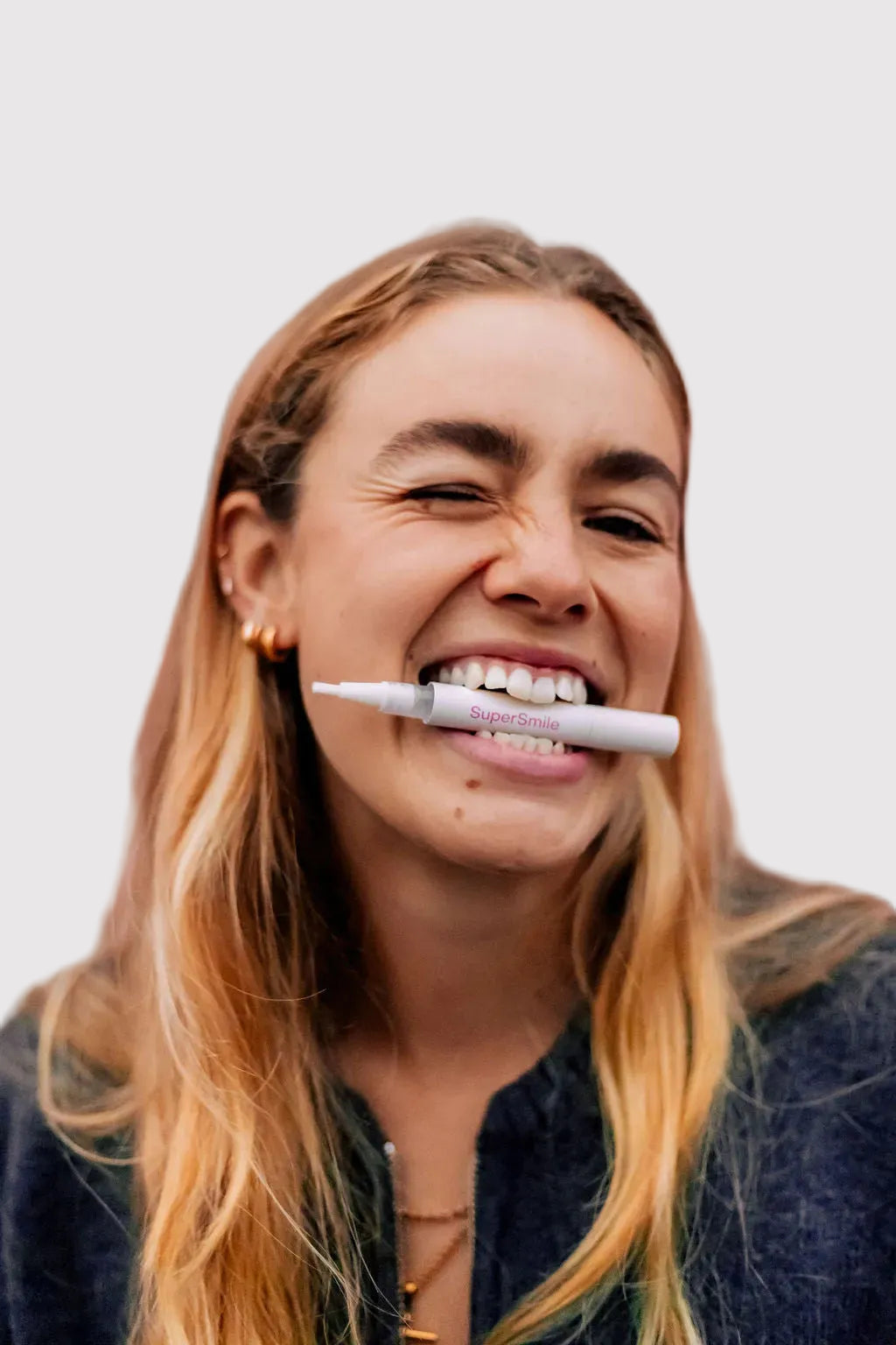 Smiling woman with the SuperSmile Advanced Teeth Whitening Pen