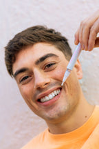 Smiling man using the SuperSmile Advanced Teeth Whitening Pen