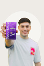 Man holding SuperSmile V34 Colour Correction Strips